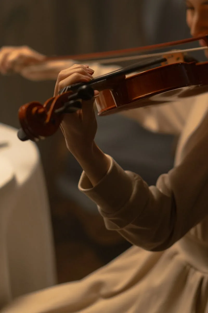 A young woman skillfully plays the violin indoors, showcasing musical talent and classical artistry.