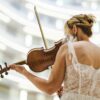 blonde woman playing on violin